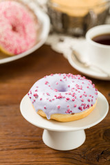 Colorful donuts on a wooden background.