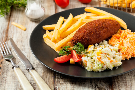 Chicken Kiev (de Volaille chop) with french fries and salads.