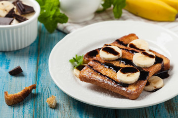 Traditional, delicious, sweet French toast with fruit and butter.