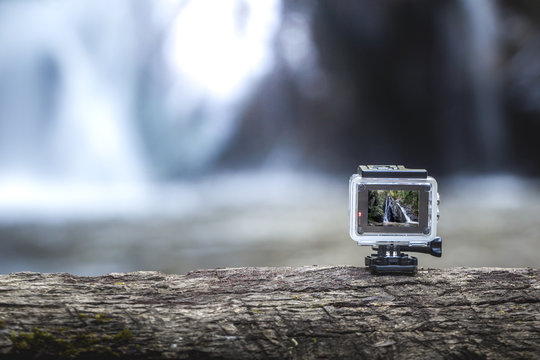 Action-cam on top of a brown tree with the waterfall behind.