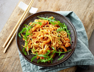 Plate of asian noodles with fried meat