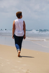 Portrait of beautiful 45 years old woman walking on seaside