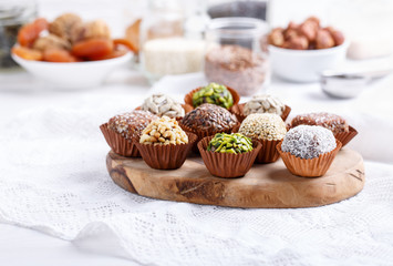 Healthy energy balls made of dried fruits and nuts with coconut chips, flax seeds, pistachios, sesame. Raw vegan candy.