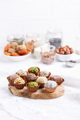 Healthy energy balls made of dried fruits and nuts with coconut chips, flax seeds, pistachios, sesame. Raw vegan candy.