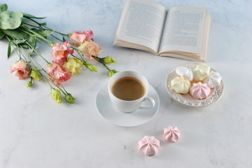 Sweet dreams ... A book, a cup of coffee, meringue, flowers. Romantic and gentle compassion. Light background. 