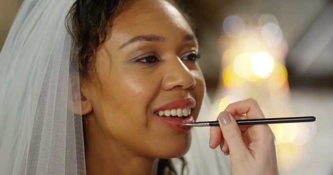 4k, A make-up artist applying make-up to a bride. Slow motion.