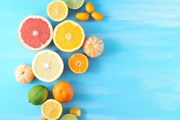 Assorted citrus fruits. In the frame, lime, kumquat, mandarin without peel, halves of orange,...