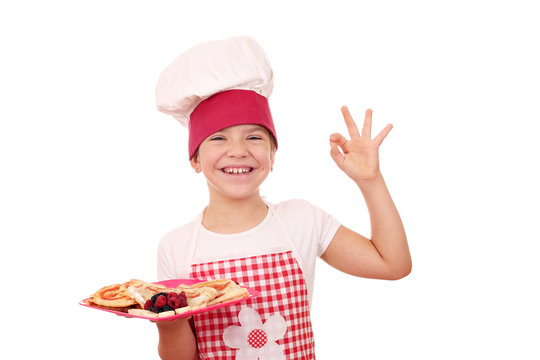 happy little girl cook with ok hand sign and sweet crepes