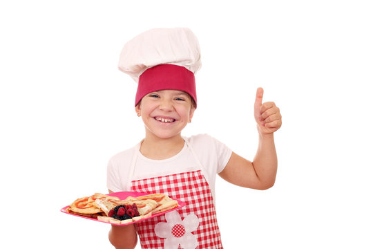 happy little girl cook with thumb up and sweet crepes
