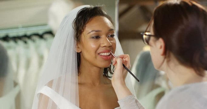 4k, A make-up artist applying make-up to a bride. Slow motion.