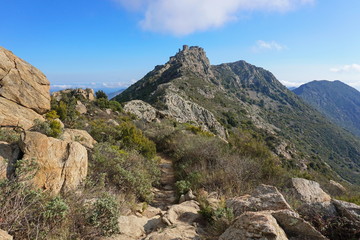 Footpath in the Verdera mountains leading to the ruins of a medieval castle located at the top of a steep rocky spur, Spain, Catalonia, Alt Emporda, Girona