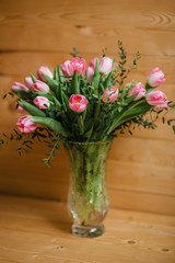 A bouquet of pink tulips in a beautiful crystal vase