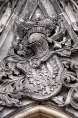 Plastic stony coat of arms above the window frame