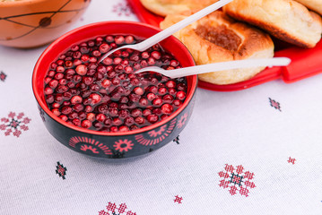 Painted plate with bilberry berries and pies