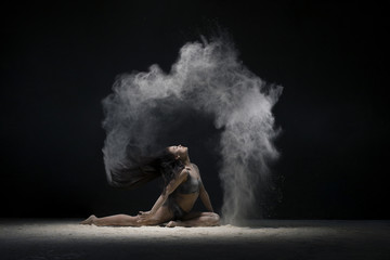 Fototapeta na wymiar Brunette in a split view in a white dust cloud