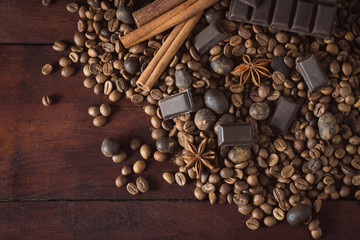 Dark Chocolate, Coffee Beans, Chocolate Balls, Spices, Cinnamon on the Old Wooden Table. Flat lay, top view