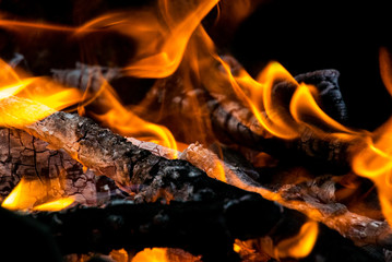 Photo of burning firewood and charcoal close-up