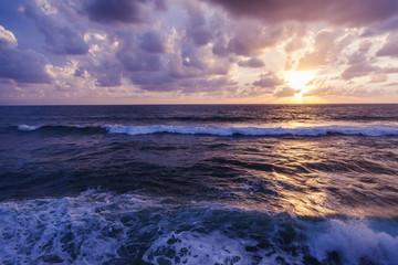 Fantastic stunning colorful sunset by the sea, waves and sunlight