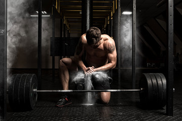 Muscular man clapping hands and preparing for workout