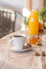 Obraz na płótnie Canvas Breakfast with coffee cups, orange juice, makaron the outdoor terrace