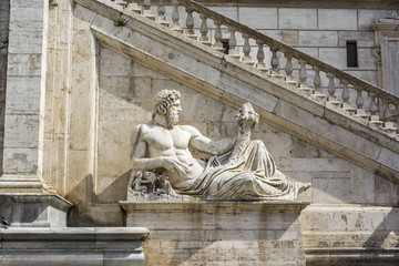 Fototapeta na wymiar Sculpture in front of stairs of Palazzo Senatorio at Piazza del Campidoglio, Rome, Italy