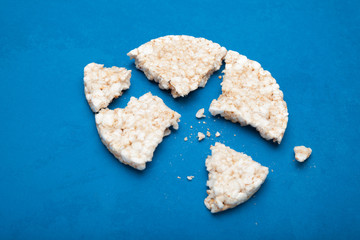 Broken rice loaf on a blue background.