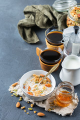Breakfast with black coffee muesli granola honey nuts milk