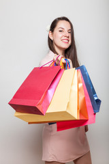 Cheerful attractive caucasian woman takes bags