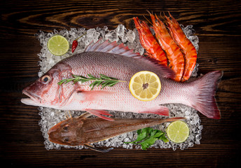 Fresh tasty seafood served on old wooden table.