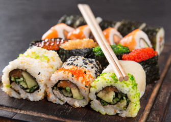 Japanese Sushi over black background.