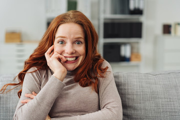 Young redhead woman with a look of anticipation