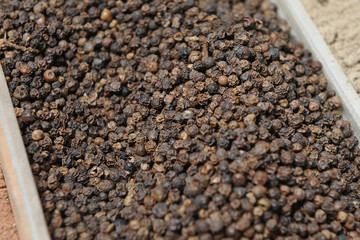 Beautiful and fresh seasoning black pepper, close-up from the seller in the market