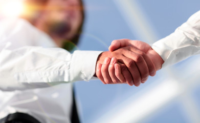 Close-up photo of handshake of two successful businessmen