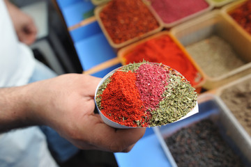 The seller of seasonings in the market, made a mix of seasonings for cooking delicious food