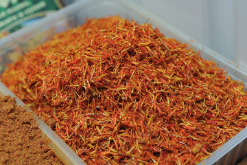 Fototapeta premium Beautiful and fresh dry seasoning saffron, close-up from the seller in the market