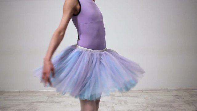Professional ballet dancer smoothly swirls. Ballerina turns round fluently