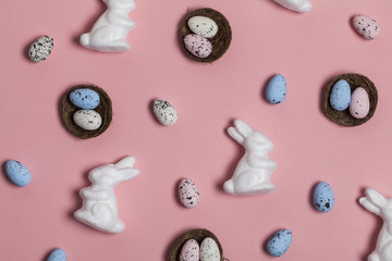 Easter background with easter eggs and easter bunnies on a pink background