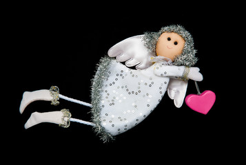 Toy angel carrying heart 