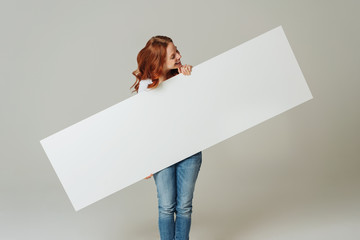 Young woman holding a blank panorama banner