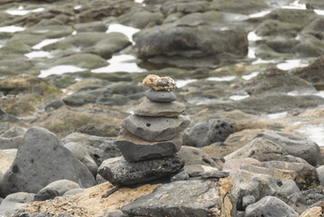 Obraz premium Stacked pebbles balancing on rocks Playa Blanca, Lanzarote, Canaries