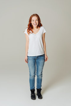 Delighted young redhead woman in jeans