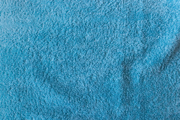 Close-up of soft turquoise towel texture background viewed from above.