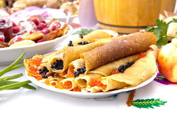 Shrovetide, pancake week, festival meal. Pancakes with red and black caviar. Rustic style.