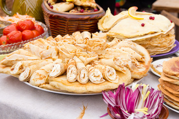 Obraz na płótnie Canvas Shrovetide, pancake week, festival meal. Pancakes with caviar, honey, jam, curd, berries . Rustic style.