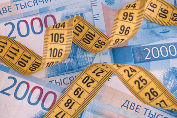 Two thousand ruble banknotes and measuring tape