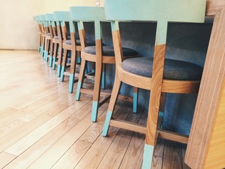 Row of wooden chairs with a mint stripes