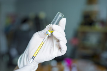 A Doctor prepared syringe of vaccine to injunction patient