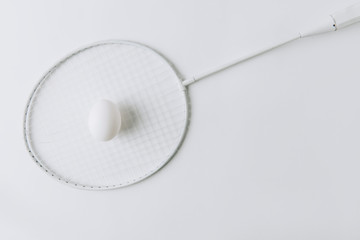 white egg laying over tennis racket