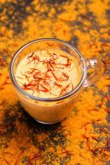 Indian turmeric milk with saffron, cardamom and turmeric. Copyspace
