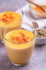 Indian turmeric milk with saffron, cardamom and turmeric. Copyspace